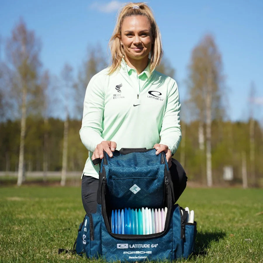 Kristin Lätt holding the Latitude 64 Core Pro E3 signature backpack open, showing disc capacity
